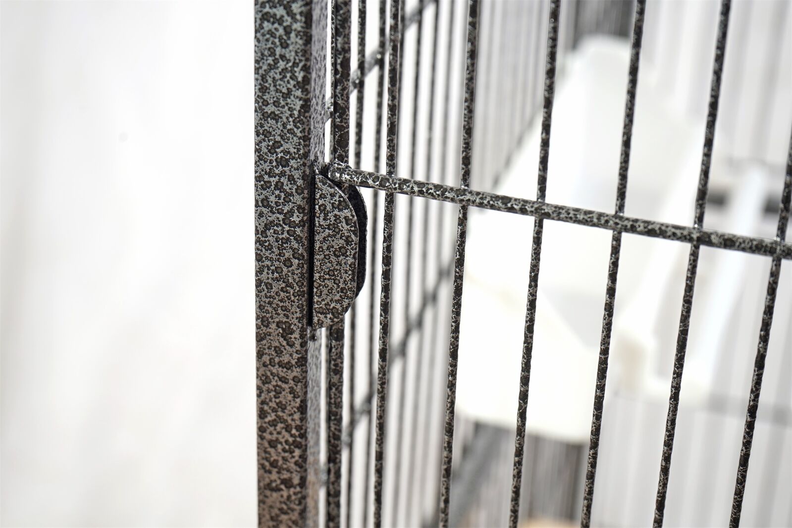 Close-up of a metal gate with a blurred background at Pet Servo