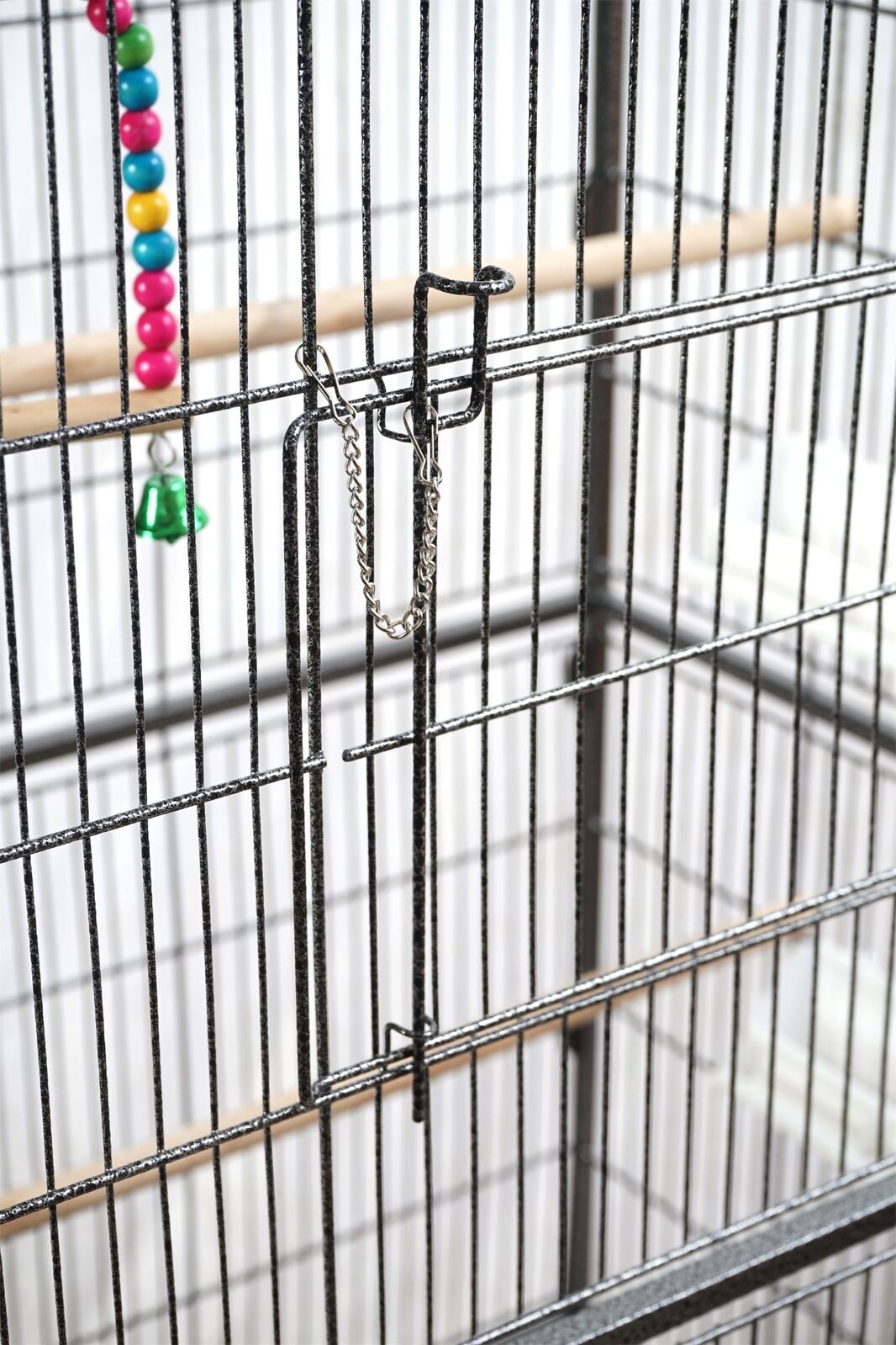 Birdcage with colorful bird toys inside at Pet Servo