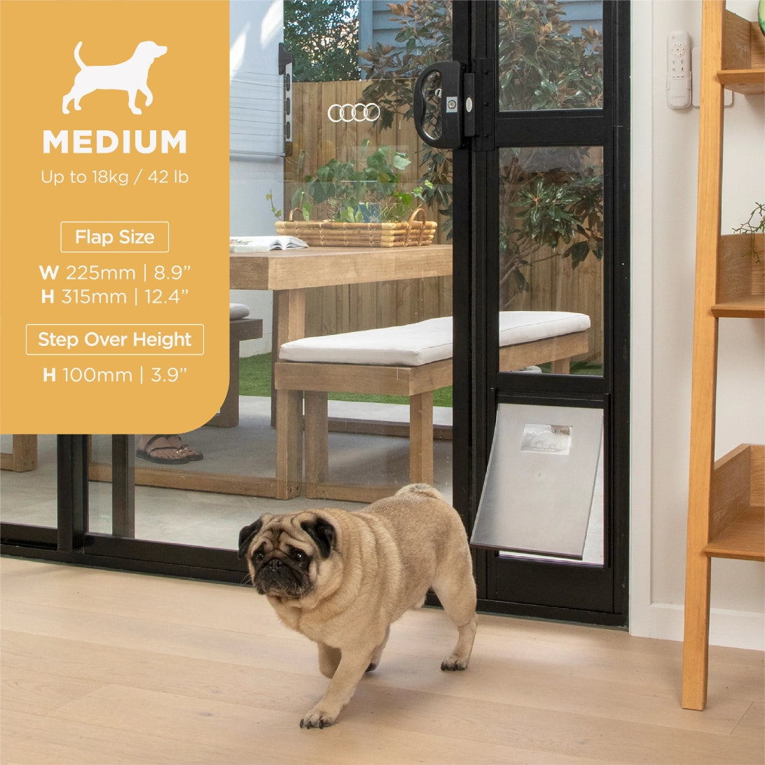 A pug stands in a home interior doorway with a pet door flap installed, while an orange size callout on the left reads MEDIUM with flap size measurements. The scene includes a real indoor/outdoor environment and an animal, so this is Lifestyle rather than Product/Packaging or Measurement Chart at Pet Servo
