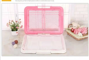 Pink mesh screen on a white surface with decorative items in the background at Pet Servo