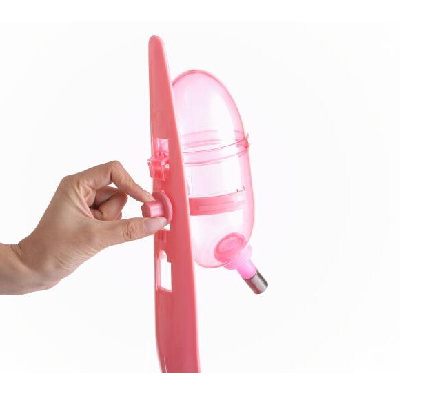 Pink handheld device with a nozzle, held by a hand on a white background at Pet Servo