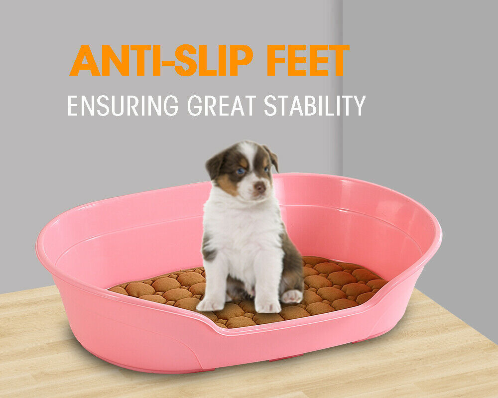 Pink pet litter box with a puppy inside on a wooden surface, featuring text about anti-slip feet at Pet Servo
