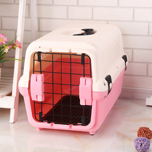 Pink and white pet carrier with a grid door on a light wooden floor  at Pet Servo
