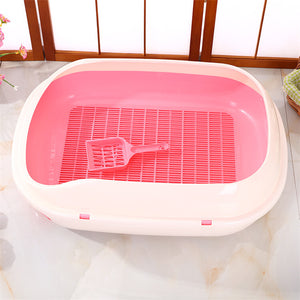 Pink and white pet litter box with a scoop on a light-colored floor at Pet Servo