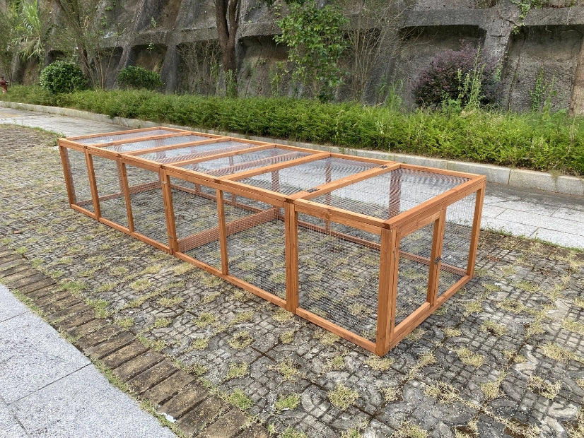 Wooden bird cage on a stone pavement with greenery in the background at Pet Servo