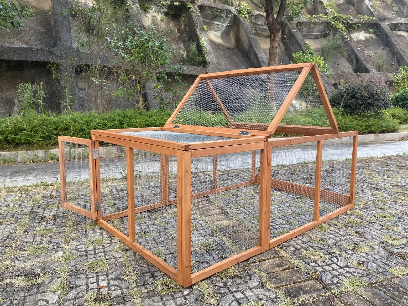 A wooden chicken coop with wire mesh panels, featuring a hinged roof that is partially open, set on a cobblestone path outdoors at Pet Servo
