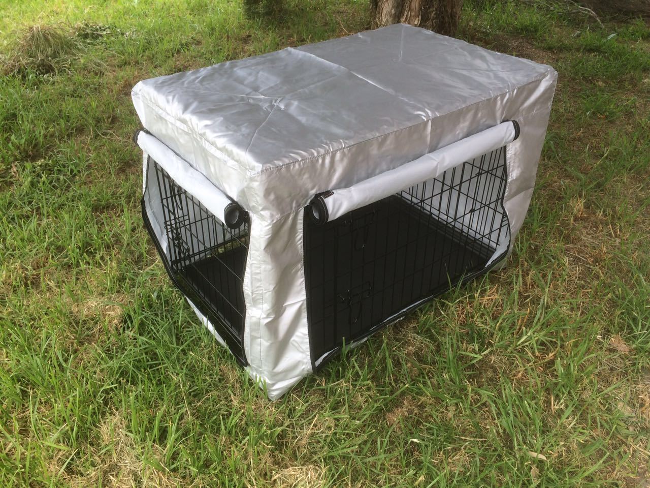 Dog crate with a cover on grass at Pet Servo