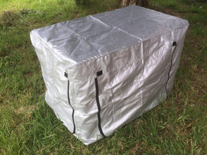Silver storage box with black straps on a grassy ground at Pet Servo