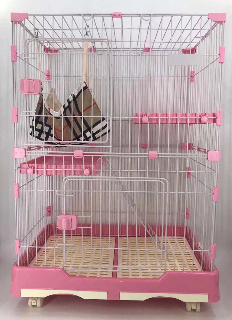 Pet cage with pink accents and a checkered bag inside on a light gray background at Pet Servo