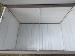 Empty wooden storage shed interior with a metal roof at Pet Servo