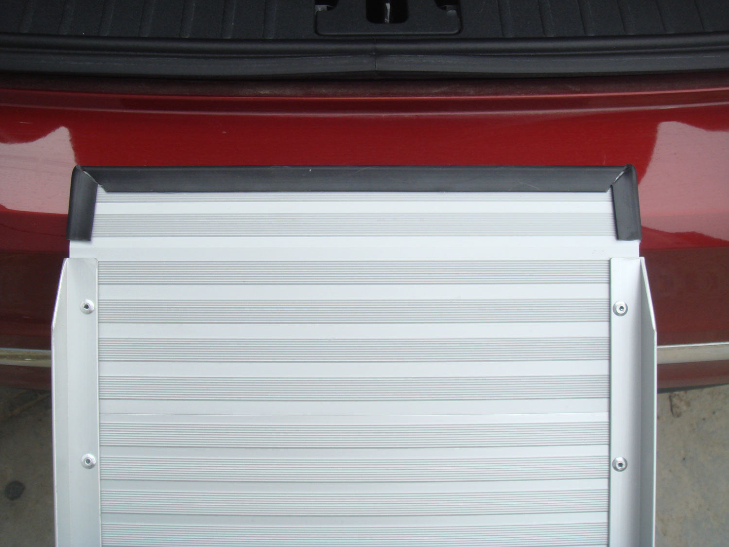 White rolling door on a red vehicle at Pet Servo