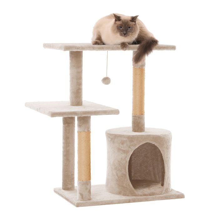 Cat tree with a cat perched on top against a white background