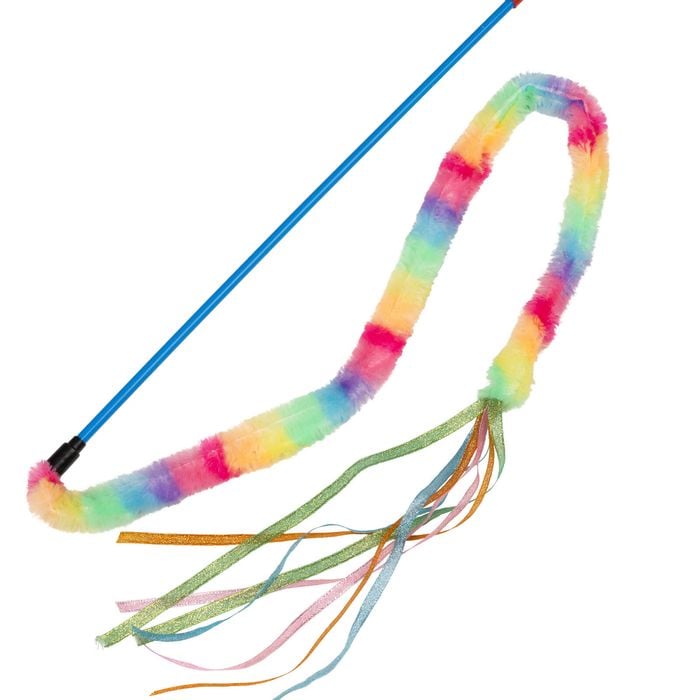 Colorful whip with rainbow handle and tassels on a white background