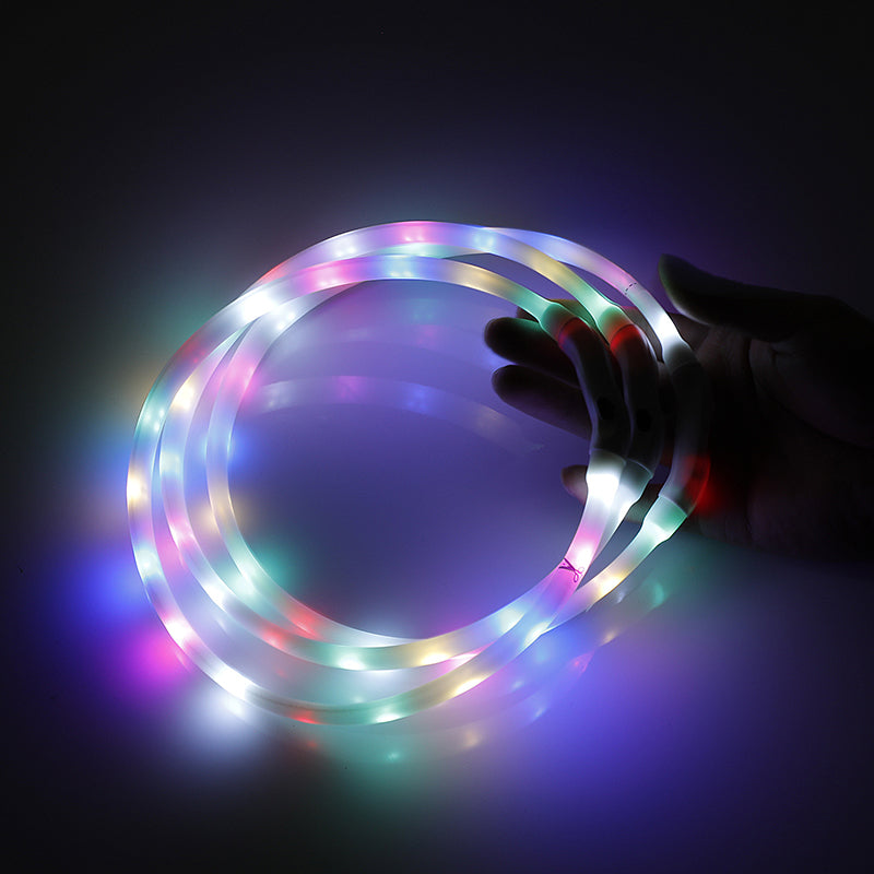 Multicolored LED light strip held by a hand against a dark background at Pet Servo