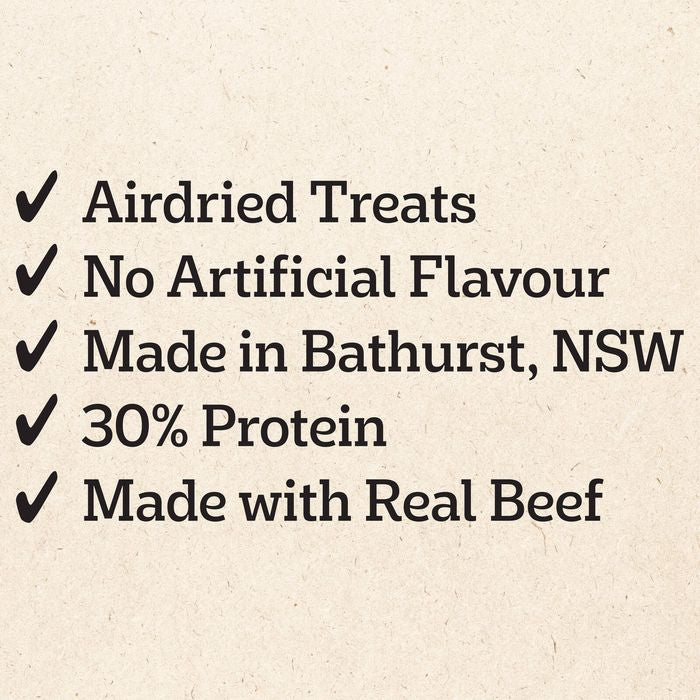 A list of product features on a textured beige background, with black text reading 'Airdried Treats', 'No Artificial Flavour', 'Made in Bathurst, NSW', '30% Protein', and 'Made with Real Beef', each preceded by a checkmark.