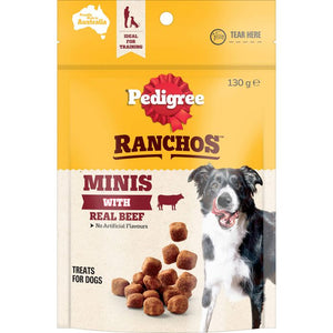 Pedigree Ranchos Minis with Real Beef dog treats pouch, featuring a yellow and cream design with a photo of a black and white dog and several brown kibble pieces shown on the front.