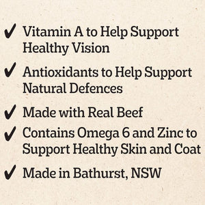 A text graphic on a textured beige background listing product benefits with checkmarks: Vitamin A for healthy vision, antioxidants for natural defenses, made with real beef, Omega 6 and Zinc for healthy skin and coat, and made in Bathurst, NSW.
