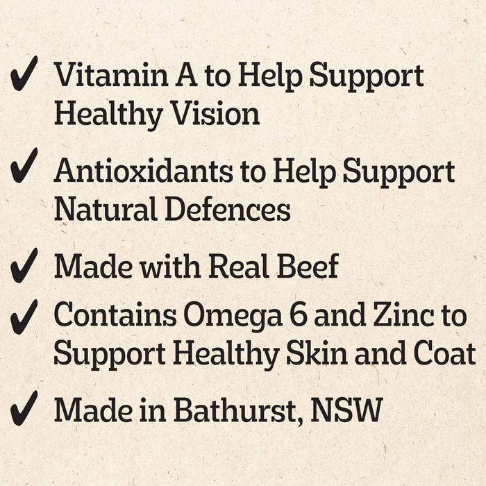 A text graphic on a textured beige background listing product benefits with checkmarks: Vitamin A for healthy vision, antioxidants for natural defenses, made with real beef, Omega 6 and Zinc for healthy skin and coat, and made in Bathurst, NSW.