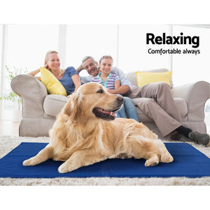 Dog lying on a blue mat with a family sitting in the background, text 'Relaxing Comfortable always' at Pet Servo