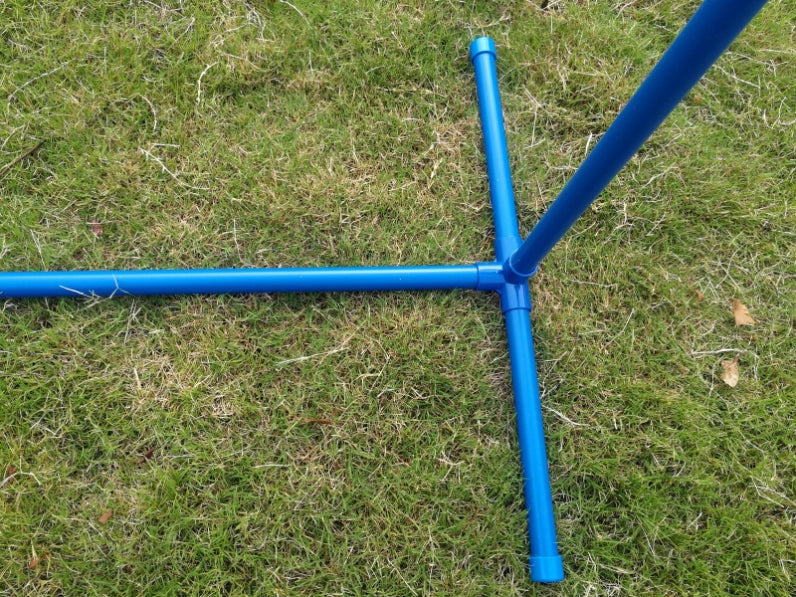 Blue metal stand legs connected at a central junction, photographed outdoors on green grass at Pet Servo