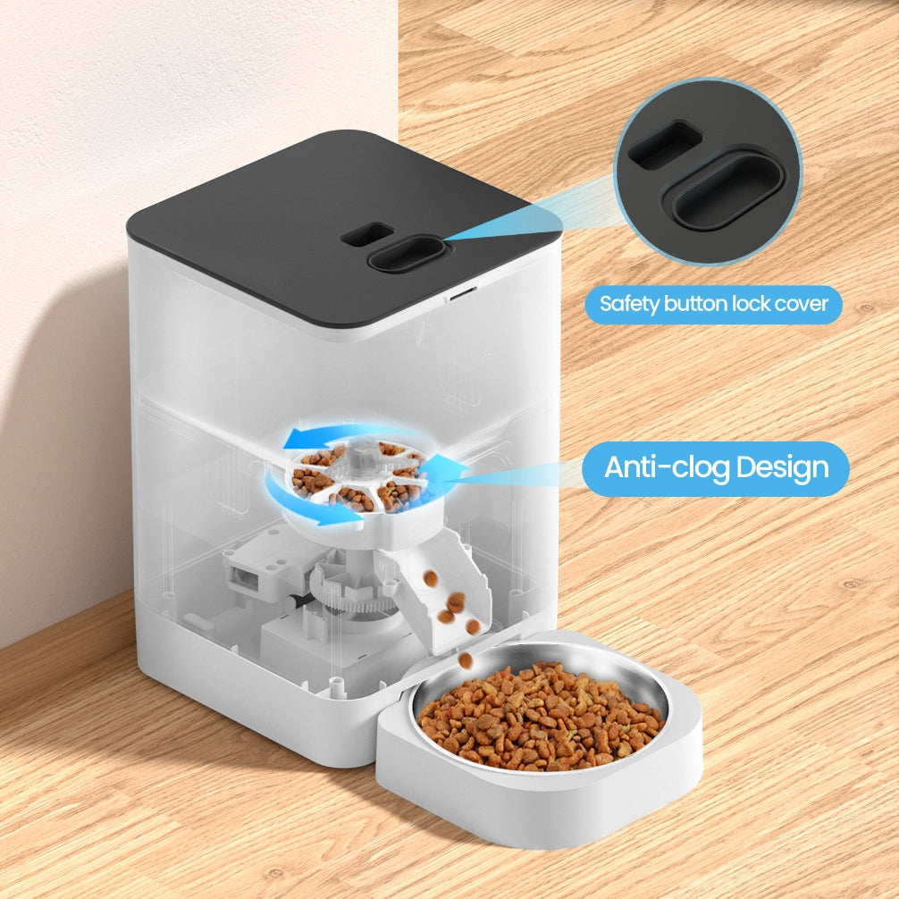 Pet food dispenser with safety button lock cover and anti-clog design on a wooden surface at Pet Servo