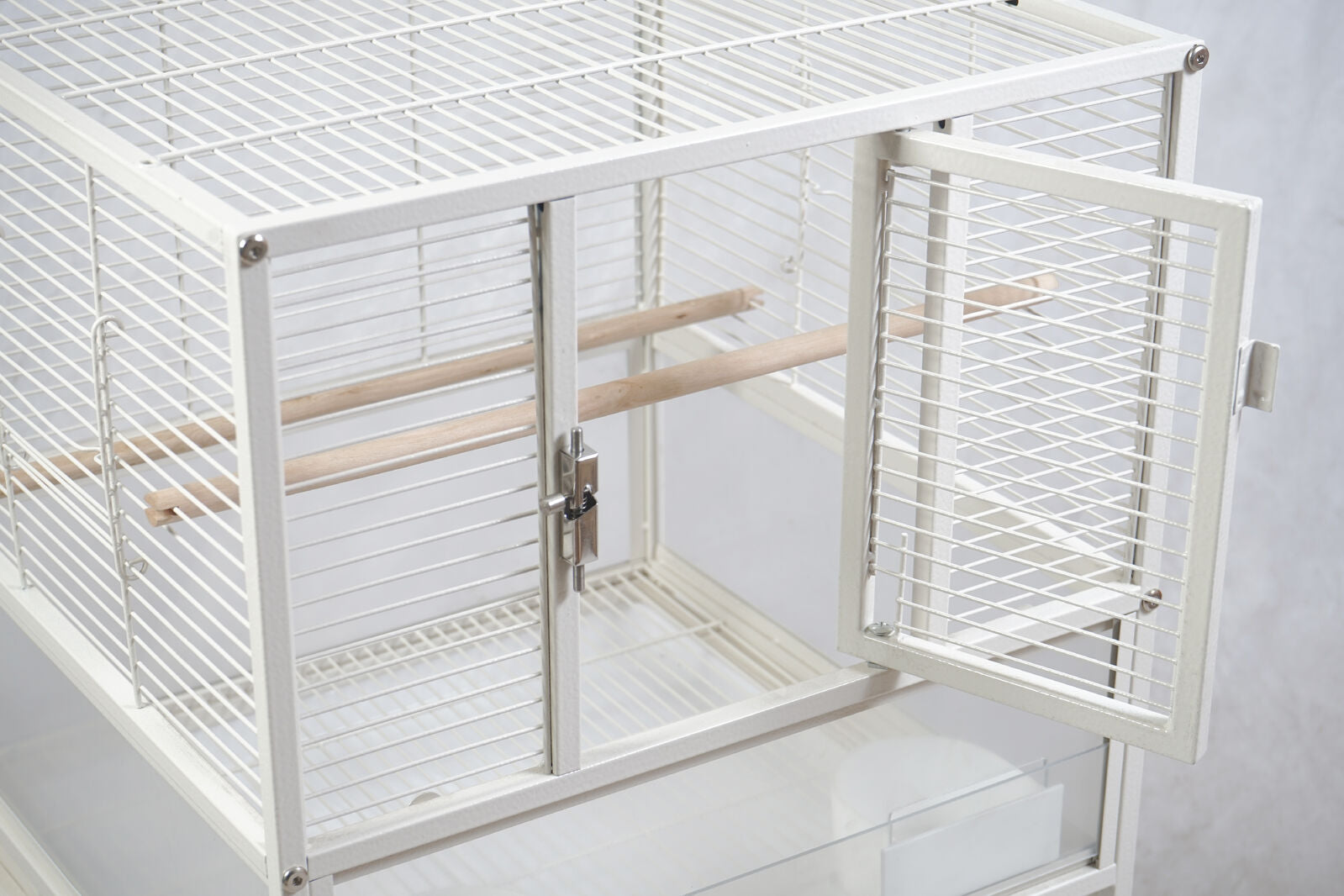 White bird cage with open door on a light gray background at Pet Servo