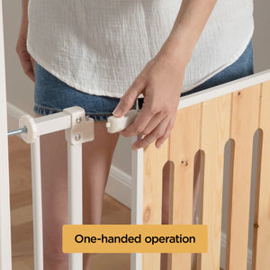 Person adjusting a baby gate with text 'One-handed operation' on a wooden staircase.