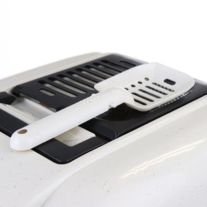 White spatula with black handle on a white surface at Pet Servo