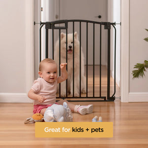 Baby sitting on the floor with a dog behind a black safety gate, with text 'Great for kids + pets'.