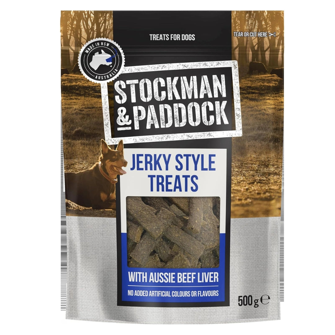A 500g bag of Stockman & Paddock Jerky Style Treats for dogs, featuring a window that displays the jerky slices inside. The packaging has a rustic brown forest background with a photo of a dog, and a silver-colored lower section at Pet Servo
