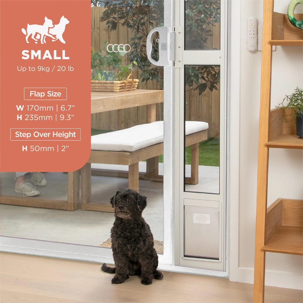 Dog sitting on a step next to a glass door with pet door, outdoor furniture visible at Pet Servo
