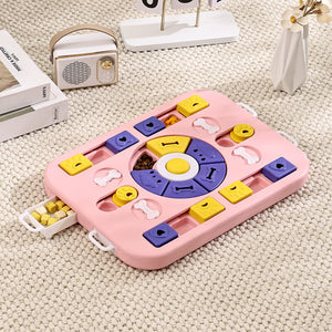 Pink puzzle toy for pets on a carpeted floor with a radio and books in the background at Pet Servo