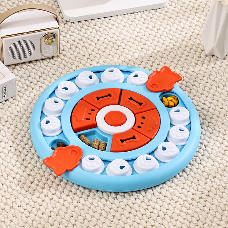 Round pet toy with blue, orange, and white colors on a beige carpet at Pet Servo 