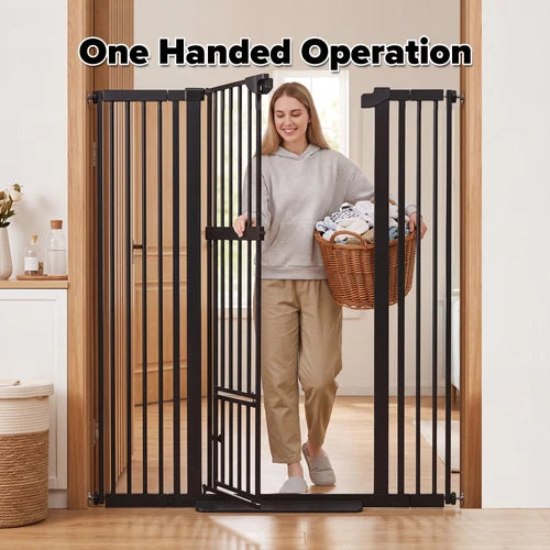 A woman walks through a black metal one-handed pet gate in a home setting, holding a wicker basket of laundry. The text 'One Handed Operation' is displayed at the top of the image at Pet Servo