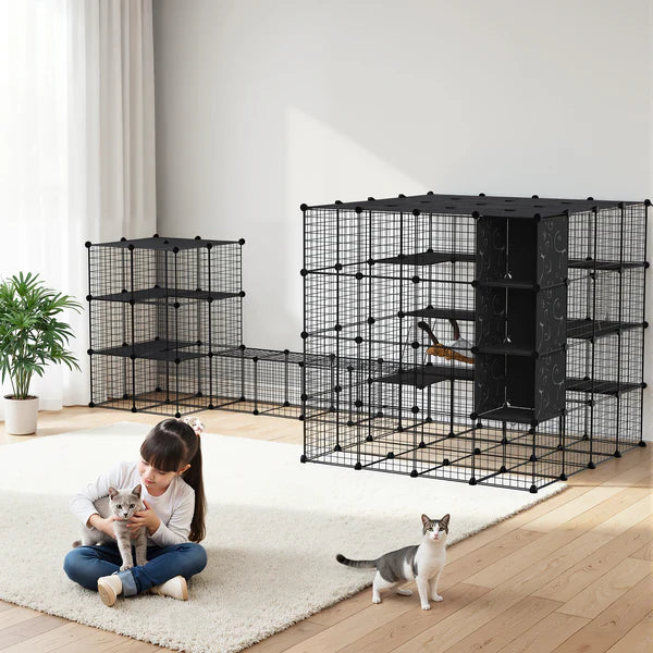 Large black pet playpen with multiple levels in a room with a child and two cats.