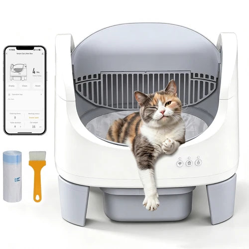 A white and gray automatic cat litter box with a calico cat lying inside, shown on a clean white background. A smartphone screen is visible on the left showing the app interface, along with two small accessories: a blue-lidded container and a yellow-handled brush at Pet Servo