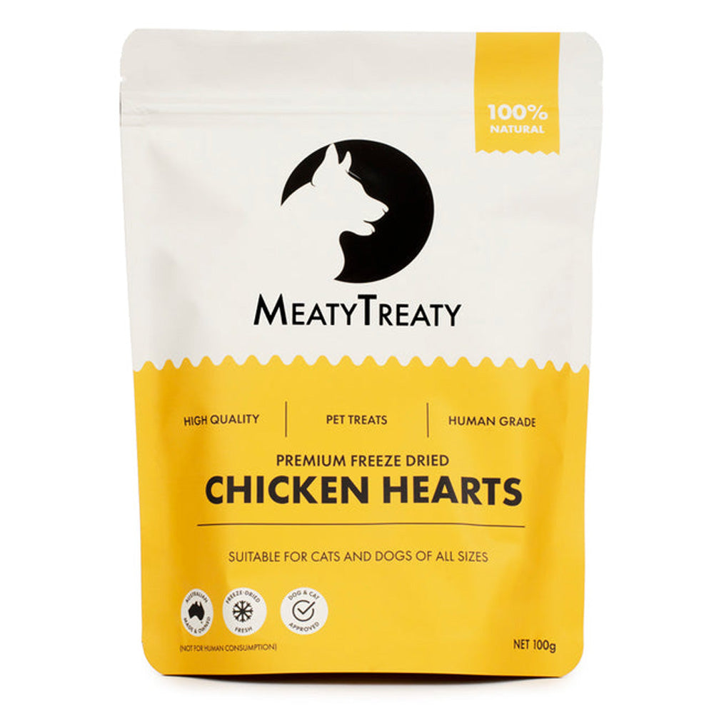 A stand-up pouch of MeatyTreaty Premium Freeze Dried Chicken Hearts pet treats, featuring a white top half with a black dog silhouette logo and a bright yellow bottom half with product text.